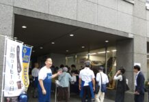 キーコーヒー、工場直送のレギュラーコーヒーが20分で完売 毎年恒例のチャリティセール実施 呼び込みを率先垂範する柴田裕社長(左)